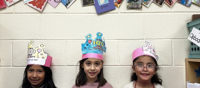 Three students holding up tally