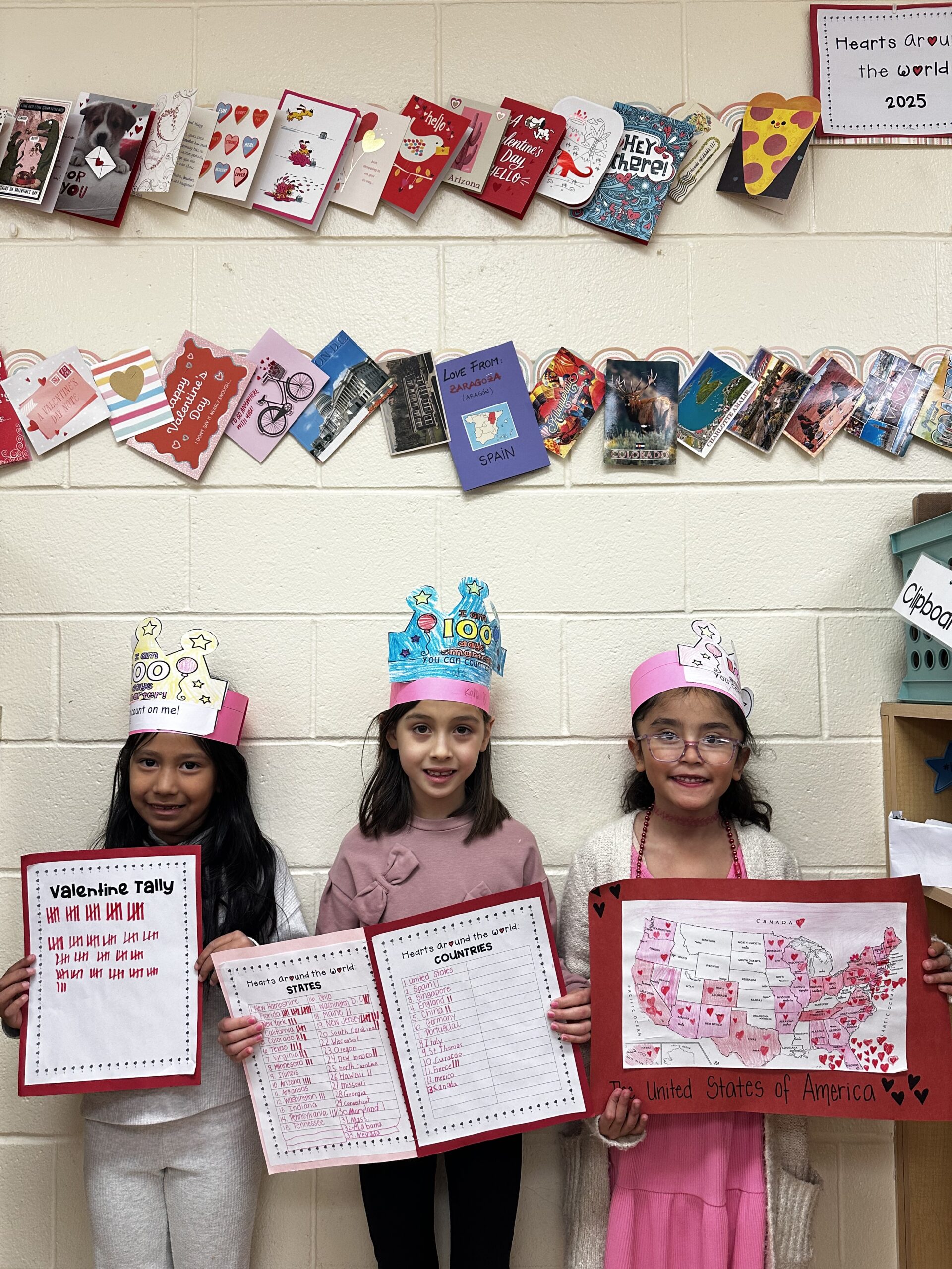 Three students holding up tally