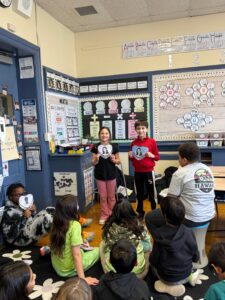 Two students presenting research