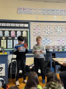 Two boys presenting research