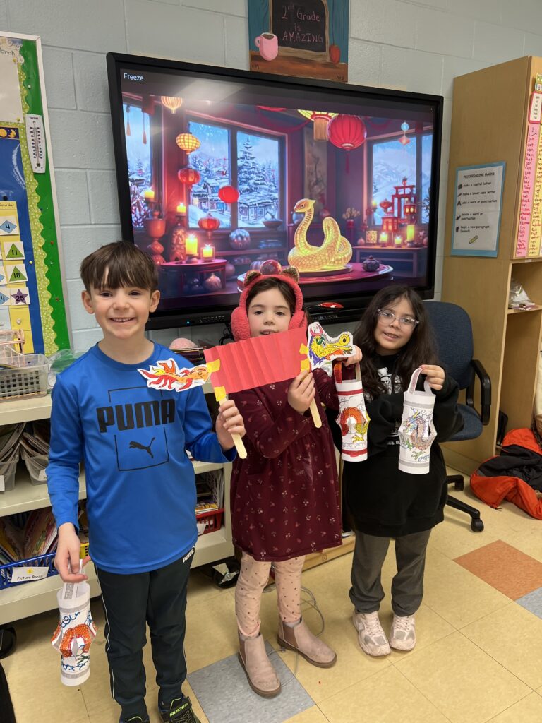 Three students with paper lanterns and paper dragon