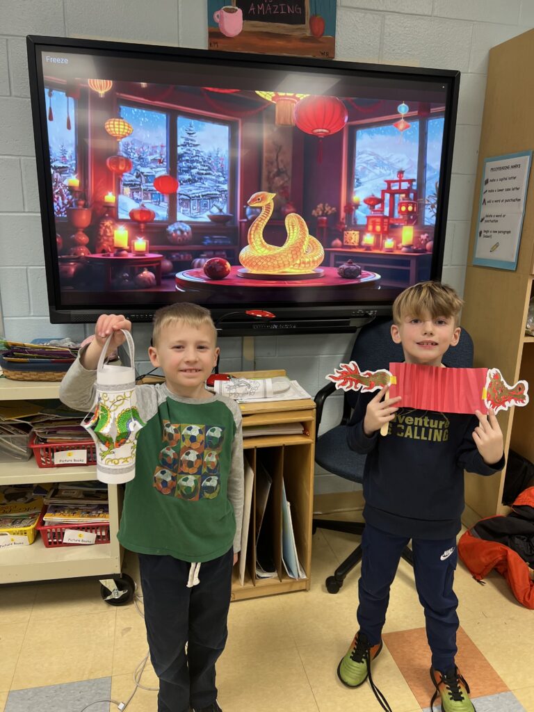 Two students with paper lantern and paper dragon