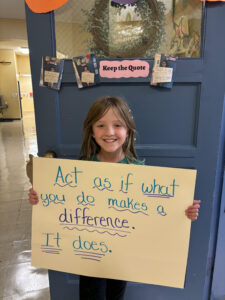 Student holding up quote