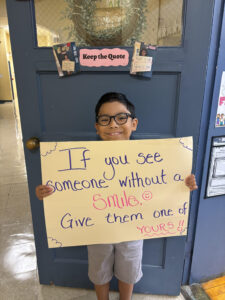 Student holding up quote