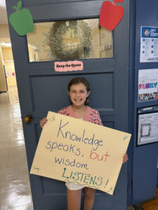 Student holding up quote