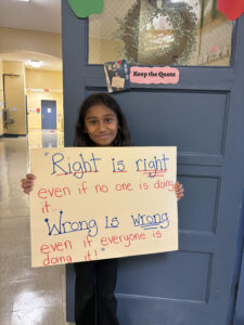 Student holding up quote